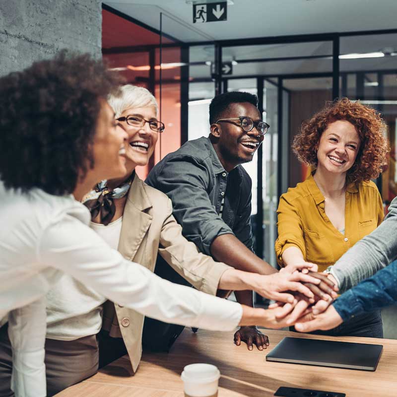 Diverse team celebrating in meeting office 