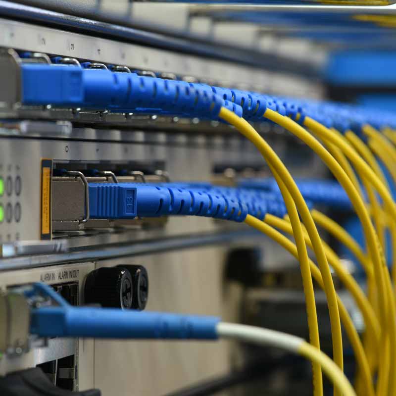 Close-up of server equipment with network cables plugged